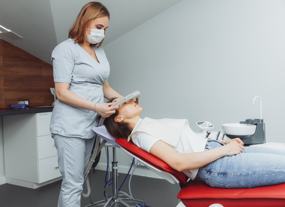 Dental technician administering nitrous oxide to a patient with dental anxiety.